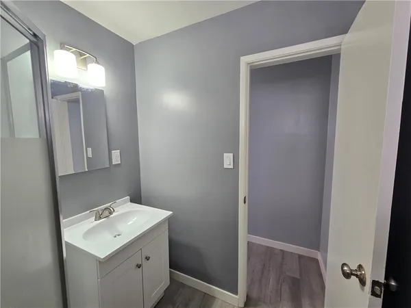 a view of a bathroom with a sink and mirror