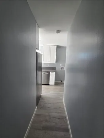 a view of a hallway with wooden floor