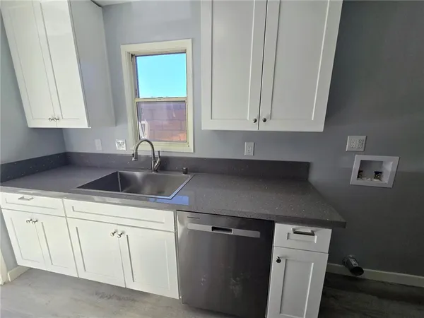 a kitchen with a sink cabinets and window