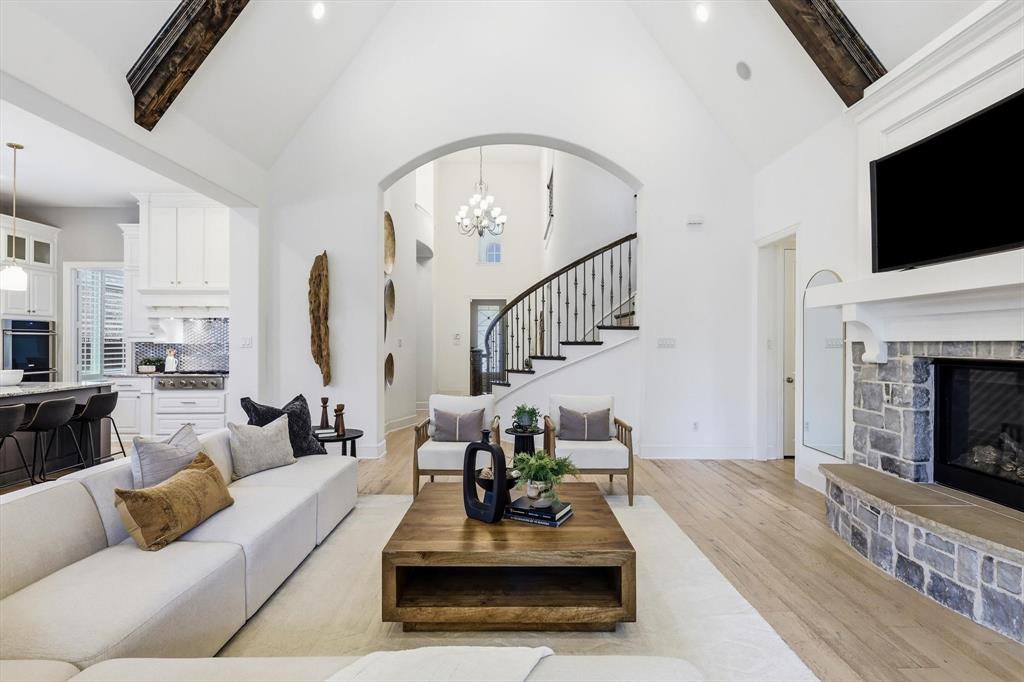 1933 Snapdragon Road Frisco, TX 75033 - Photo 17 of 40 Vaulted ceilings with exposed wood beams highlight this living space featuring wood-finish flooring