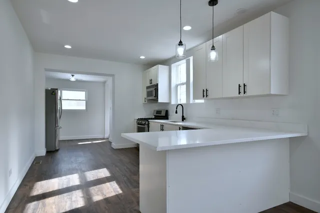 a view of a kitchen counter space a sink and dishwasher