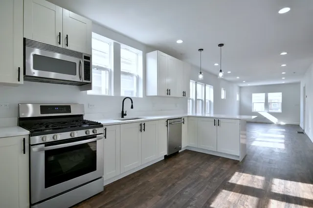 a kitchen with a stove a sink and a microwave