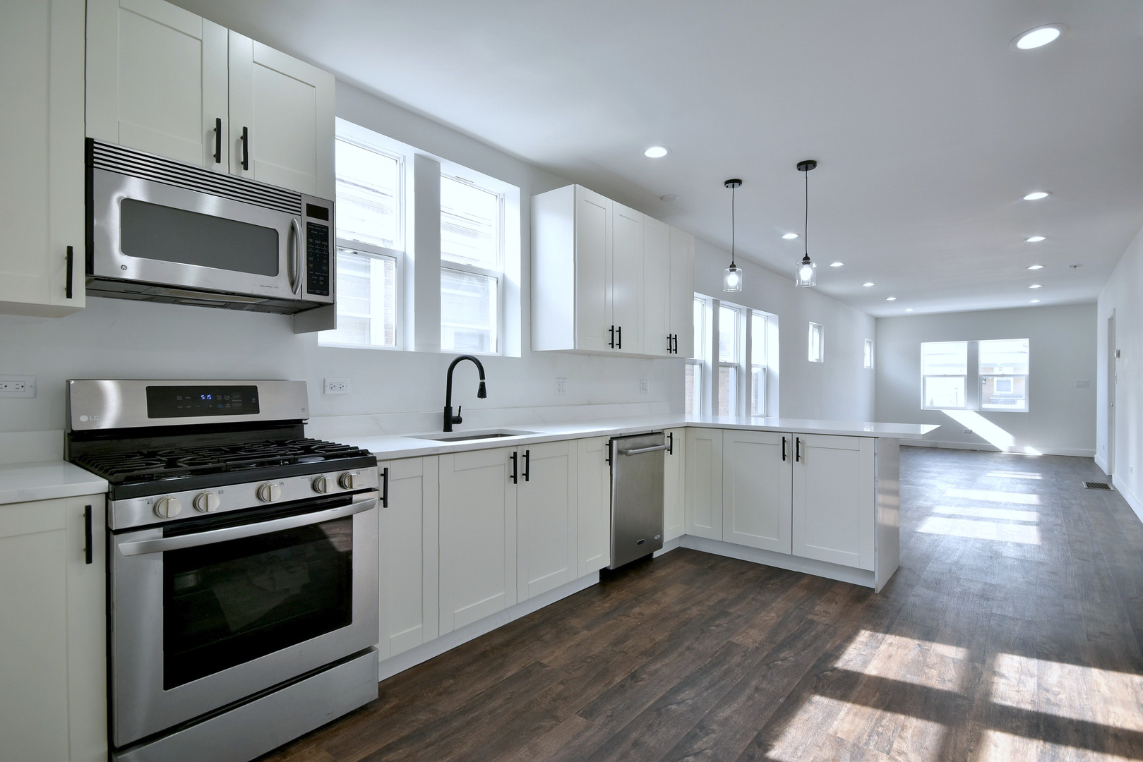 1405 South Central Avenue Cicero, IL 60804 - Photo 13 of 23 a kitchen with a stove a sink and a microwave