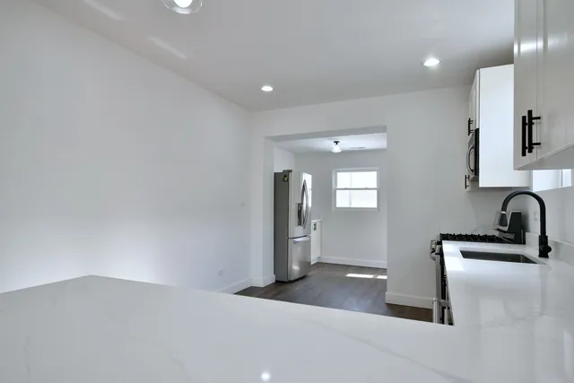 a kitchen with a sink and refrigerator