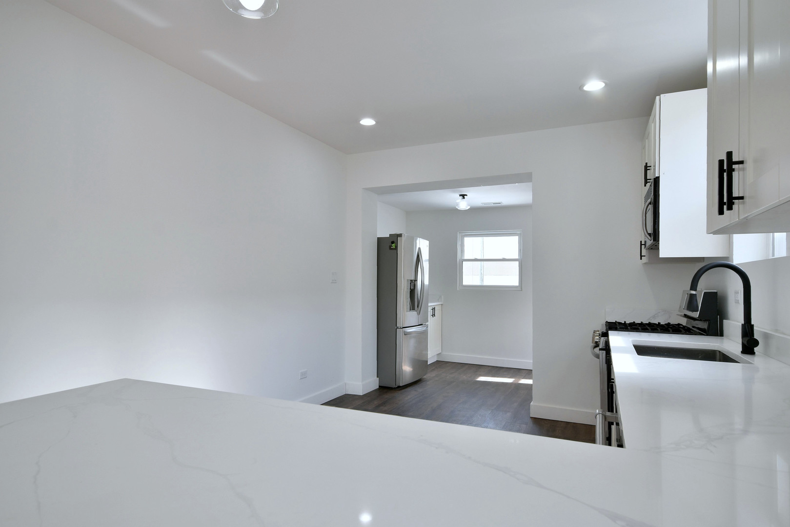 1405 South Central Avenue Cicero, IL 60804 - Photo 15 of 23 a kitchen with a sink and refrigerator