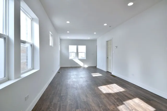 a view of entryway with wooden floor and windows