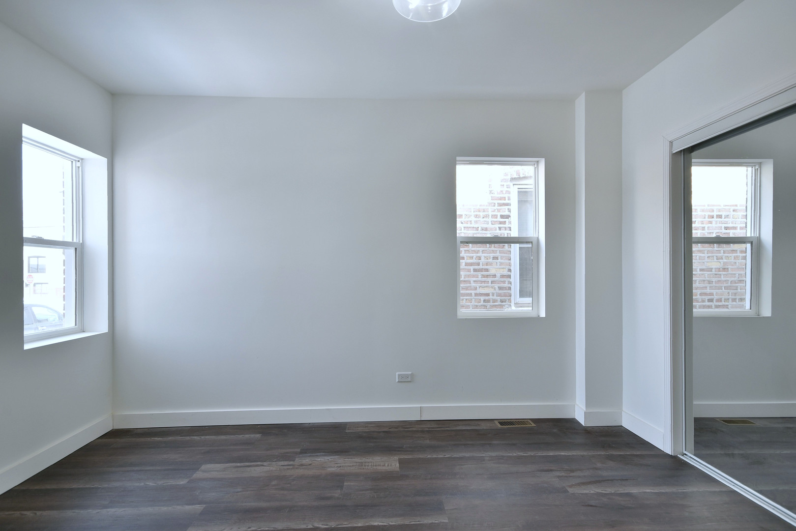 1405 South Central Avenue Cicero, IL 60804 - Photo 8 of 23 an empty room with wooden floor and windows