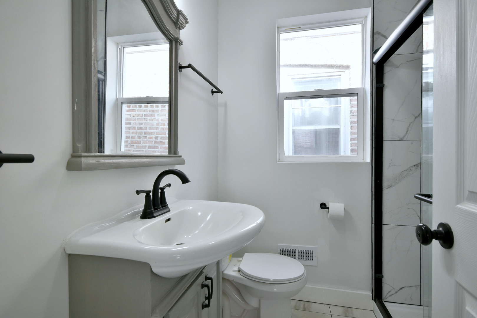 1405 South Central Avenue Cicero, IL 60804 - Photo 9 of 23 a bathroom with a sink toilet and a mirror