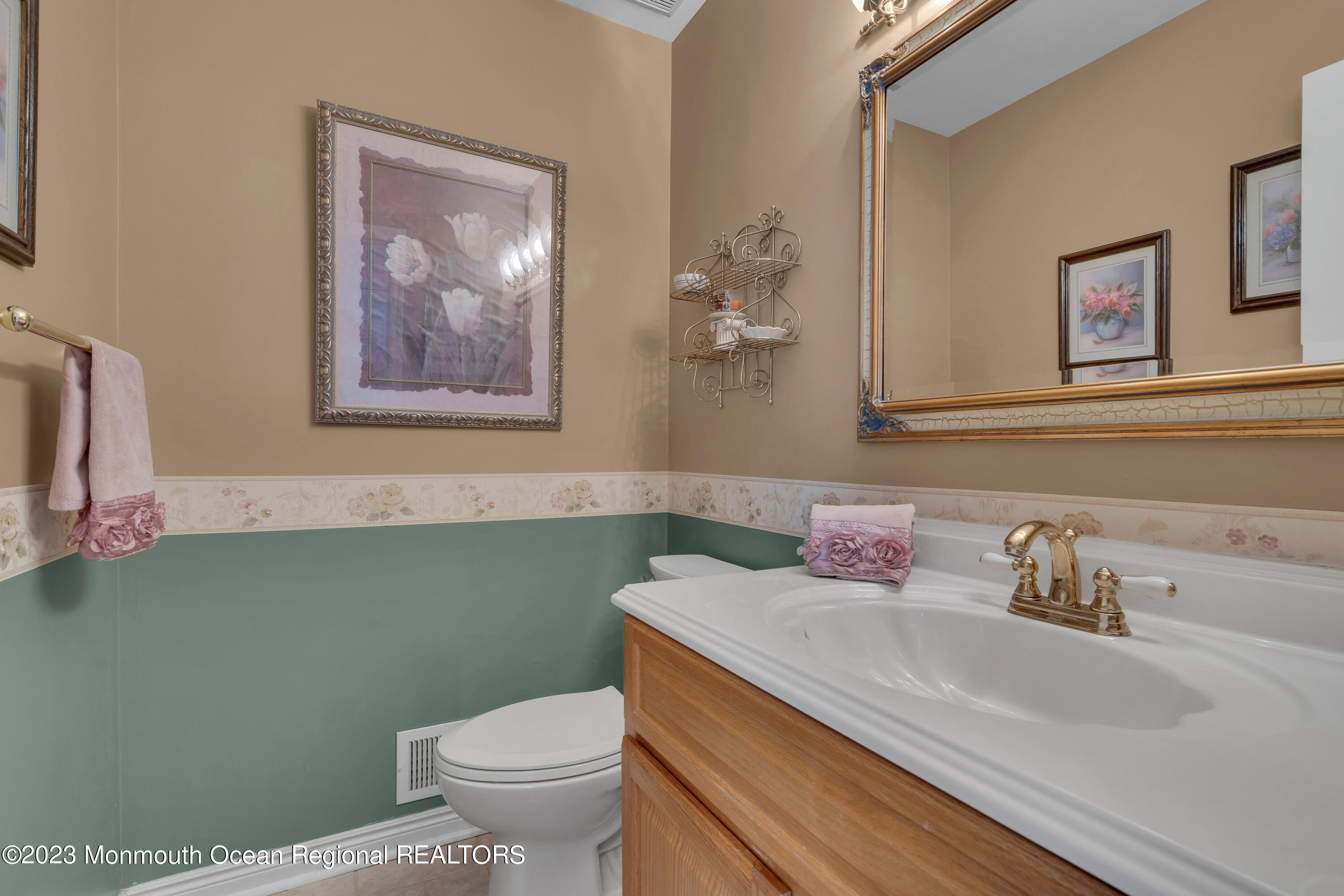 15 Old Scots Road Marlboro, NJ 07746 - Photo 18 of 59 a bathroom with a granite countertop sink a mirror and a toilet