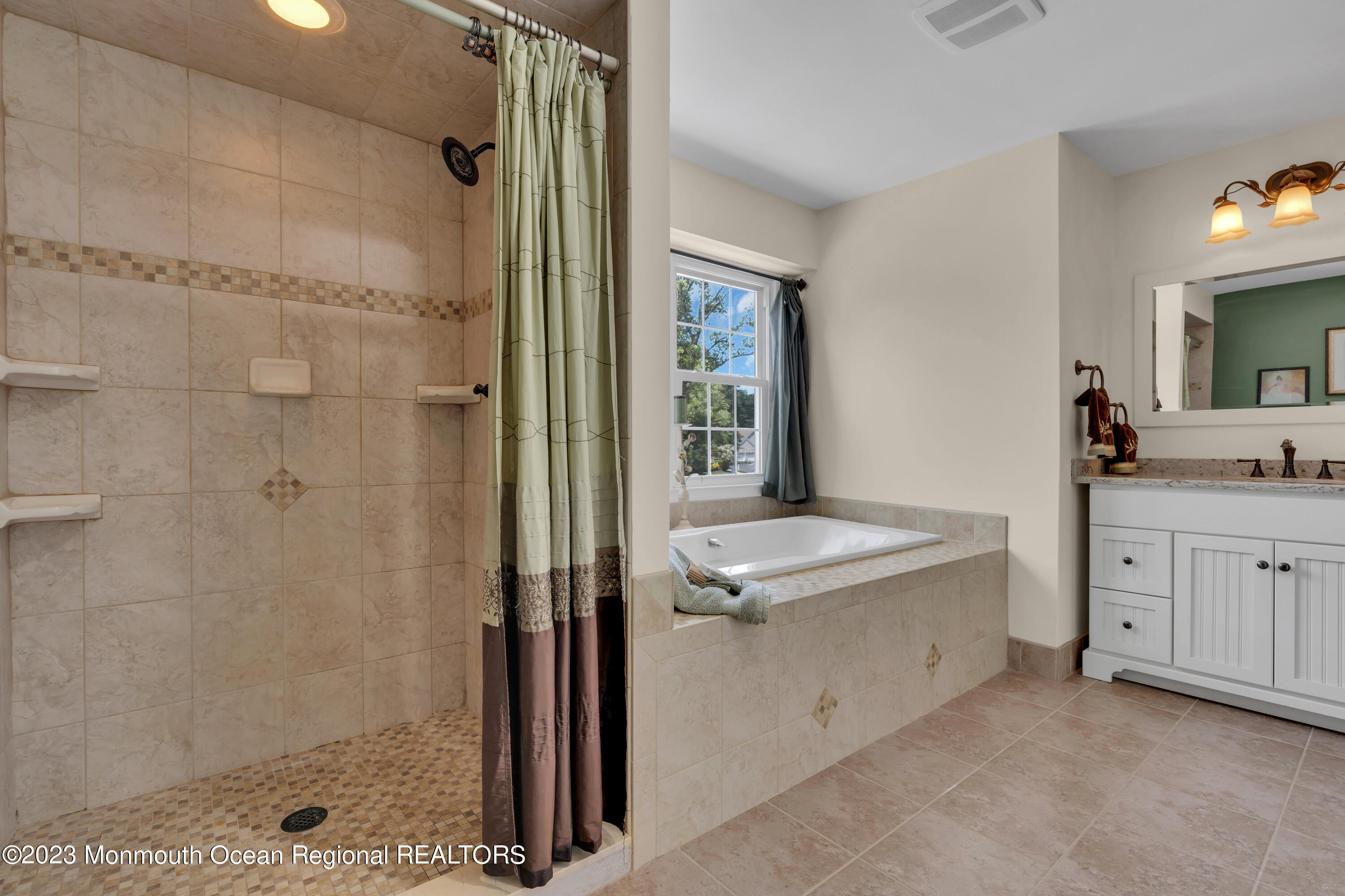 15 Old Scots Road Marlboro, NJ 07746 - Photo 21 of 59 a bathroom with a granite countertop sink a mirror and a shower