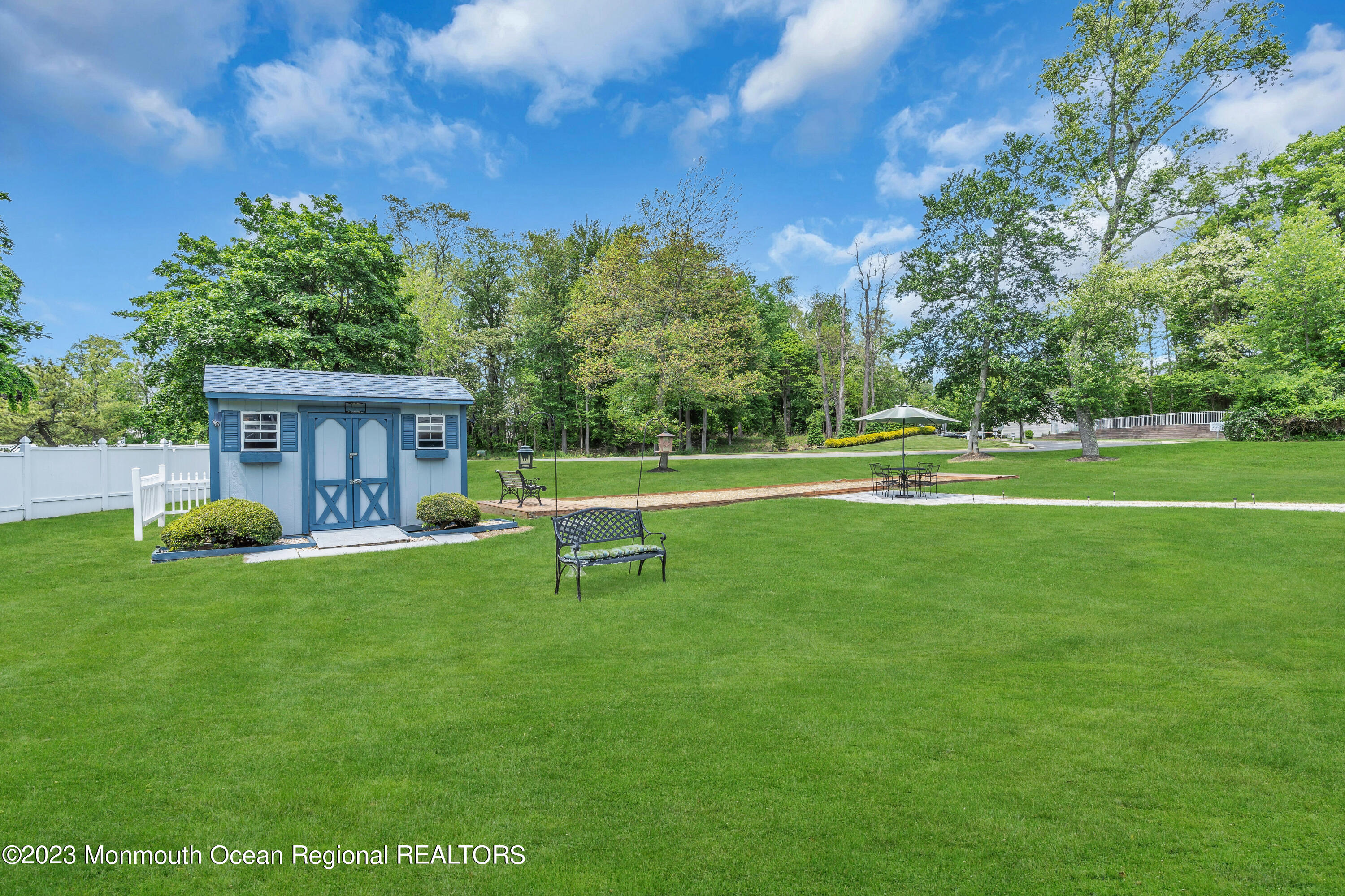 15 Old Scots Road Marlboro, NJ 07746 - Photo 53 of 59 a view of a house with a yard and a bench