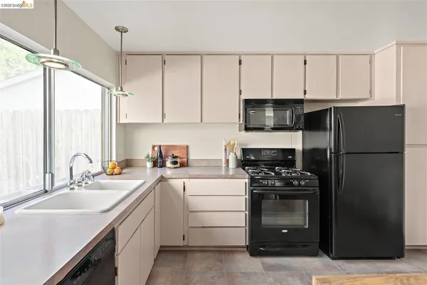 a kitchen with a sink appliances and cabinets