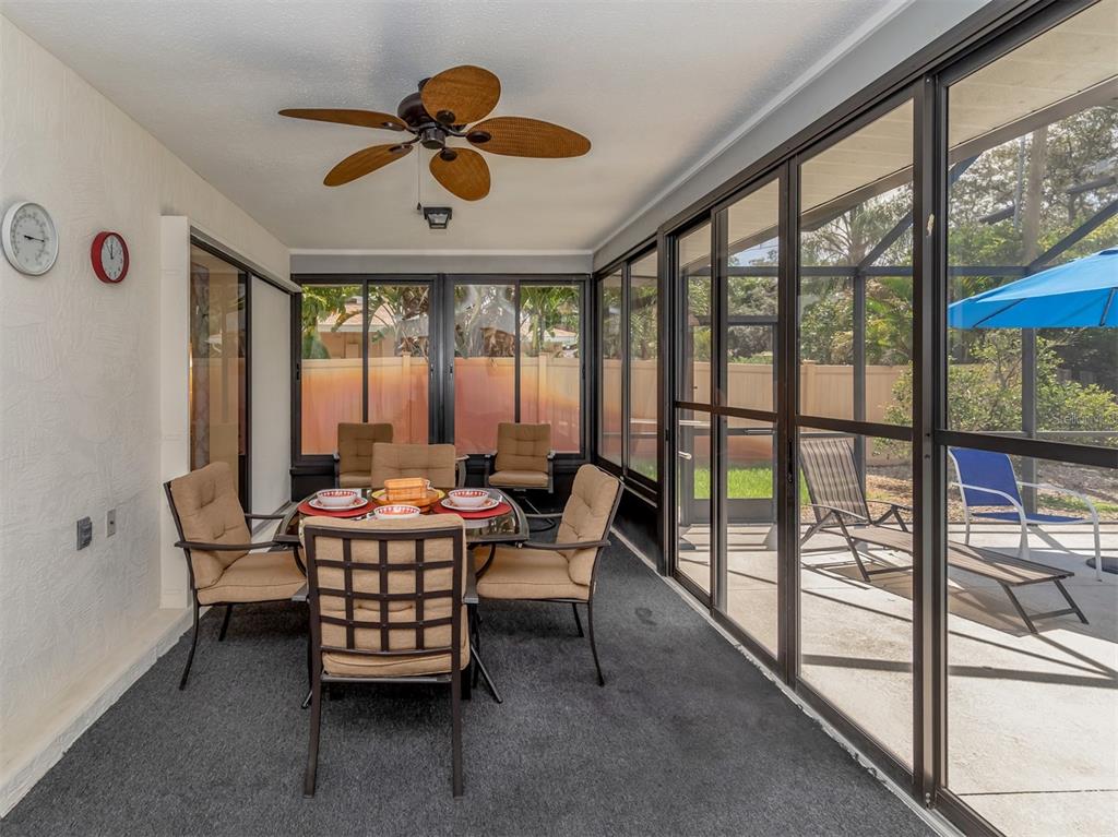 1211 Southland Road Venice, FL 34293 - Photo 15 of 80 a dining room with furniture water view and a large window