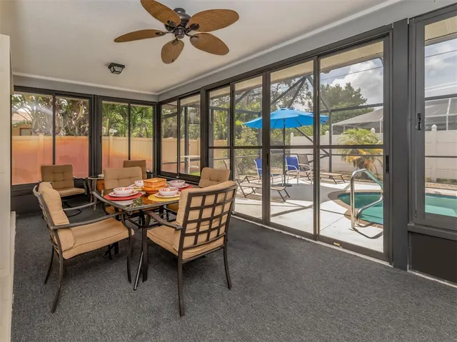 a kitchen with stainless steel appliances granite countertop a stove top oven a sink dishwasher a dining table and chairs with wooden floor