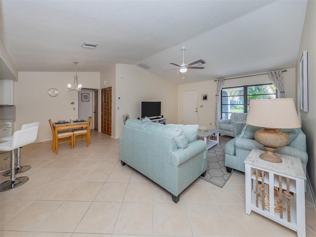 1211 Southland Road Venice, FL 34293 - Photo 25 of 80 a living room with furniture and a table