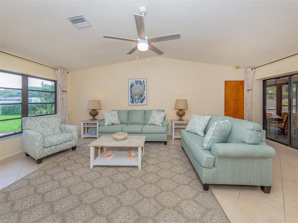 1211 Southland Road Venice, FL 34293 - Photo 28 of 80 a living room with furniture and a large window
