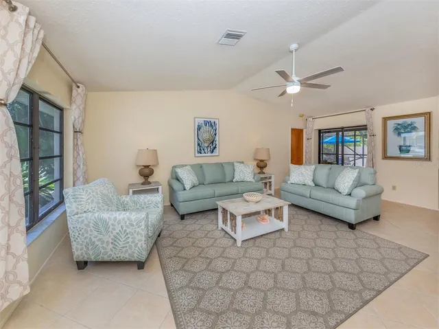 an aerial view of residential houses with outdoor space and trees
