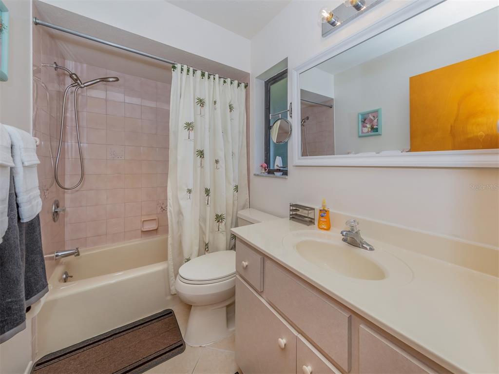 1211 Southland Road Venice, FL 34293 - Photo 33 of 80 a bathroom with a sink a toilet and shower