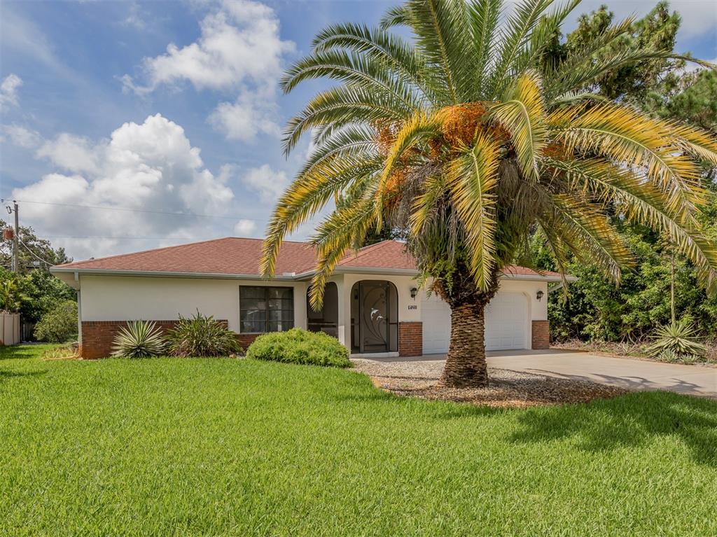 1211 Southland Road Venice, FL 34293 - Photo 5 of 80 a front view of a house with garden