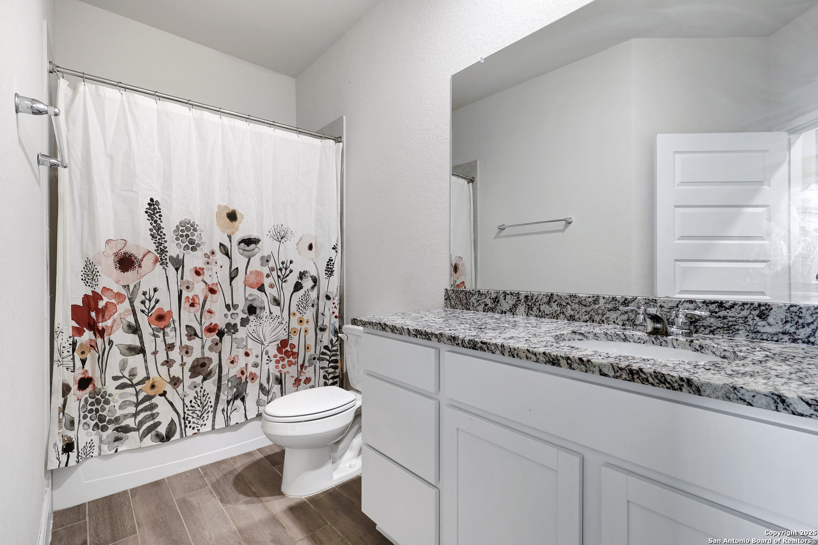 618 Bronze Streme Cibolo, TX 78108 - Photo 19 of 27 a bathroom with a granite countertop sink a toilet and a shower curtain