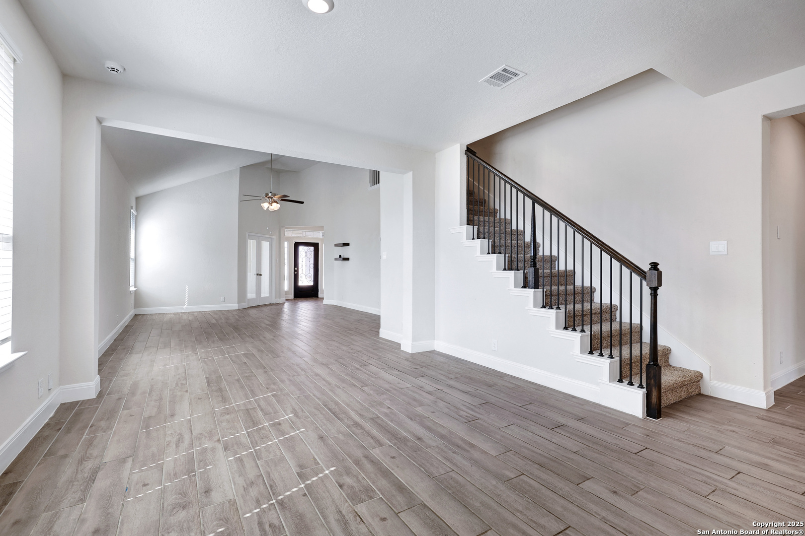 618 Bronze Streme Cibolo, TX 78108 - Photo 8 of 27 a view of a hallway with wooden floor staircase and a living room