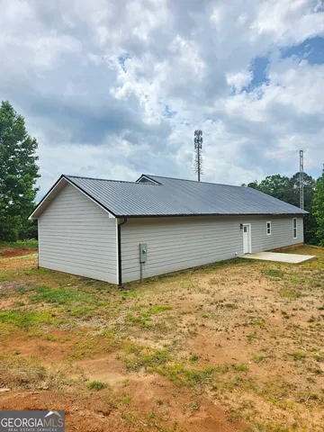 a view of a yard with potted plants