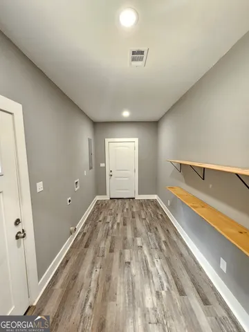 a view of a room with wooden floor and bench
