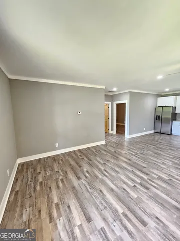 a kitchen with granite countertop stainless steel appliances a refrigerator and cabinets