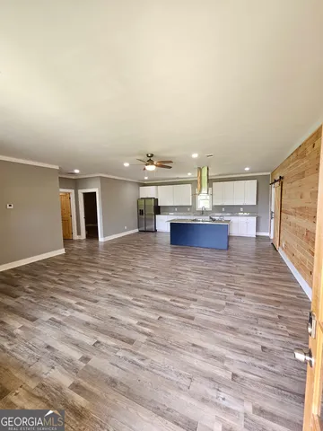 a view of kitchen and hall with wooden floor