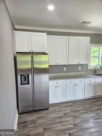 a view of an empty room and wooden floor
