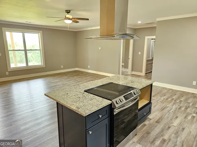 a large kitchen with stainless steel appliances granite countertop a sink and cabinets