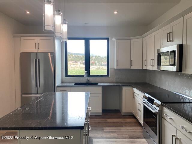 298 Blackhawk Drive New Castle, CO 81647 - Photo 3 of 15 a kitchen with stainless steel appliances granite countertop a refrigerator a sink a stove and island
