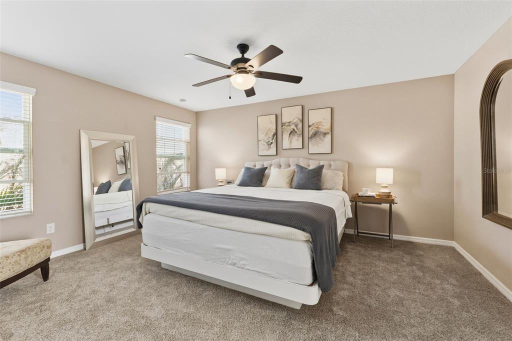 6058 Fishhawk Crossing Boulevard Lithia, FL 33547 - Photo 11 of 47 a bedroom with a large bed and a chandelier