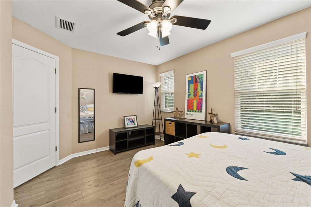 6058 Fishhawk Crossing Boulevard Lithia, FL 33547 - Photo 16 of 47 a bedroom with a bed and a flat screen tv
