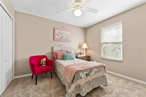 a bedroom with a bed chair and window