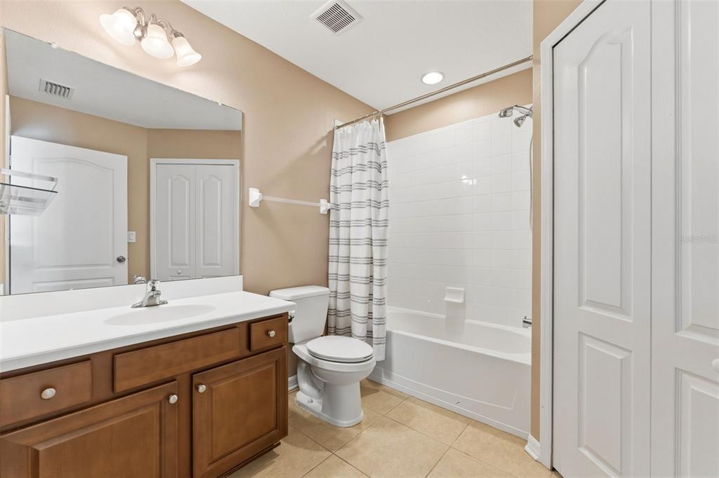 6058 Fishhawk Crossing Boulevard Lithia, FL 33547 - Photo 24 of 47 a bathroom with a double vanity sink toilet mirror and shower