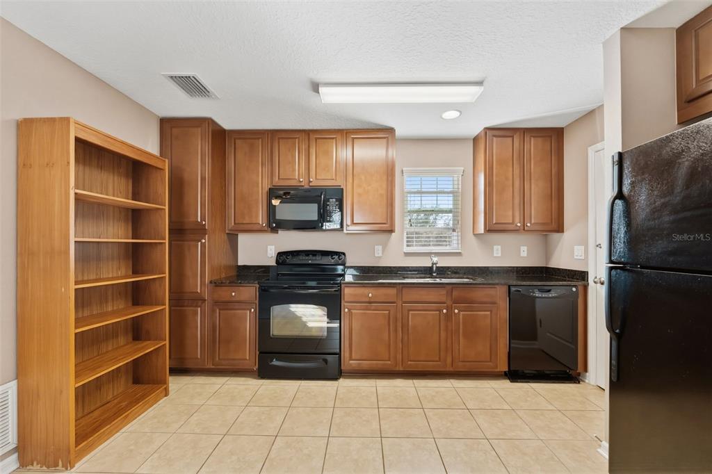 6058 Fishhawk Crossing Boulevard Lithia, FL 33547 - Photo 26 of 47 a kitchen with granite countertop a refrigerator and a sink