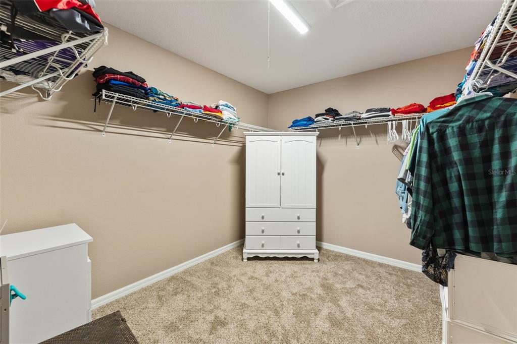 6058 Fishhawk Crossing Boulevard Lithia, FL 33547 - Photo 31 of 47 a view of walk in closet with clothes and shoes