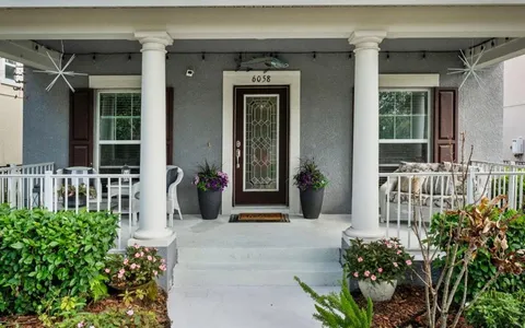 front view of a house with potted plants