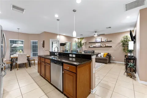 a kitchen with stainless steel appliances granite countertop a sink and a stove