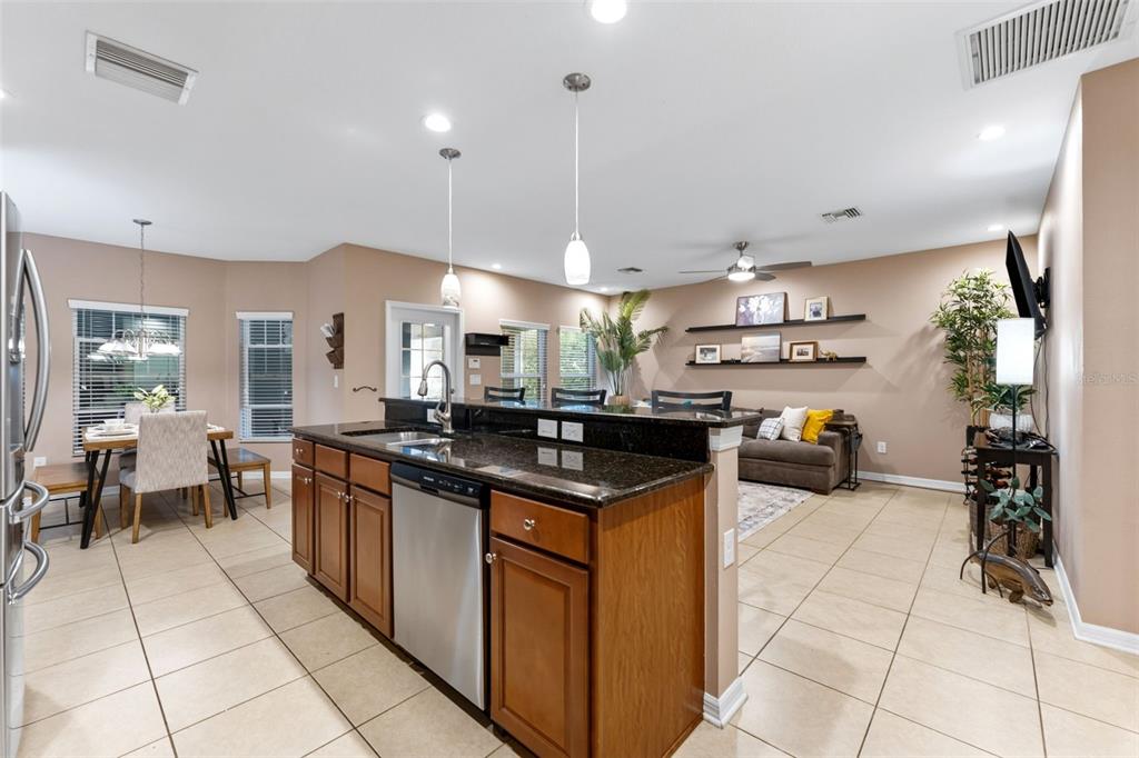 6058 Fishhawk Crossing Boulevard Lithia, FL 33547 - Photo 46 of 47 a kitchen with stainless steel appliances granite countertop a sink and a stove