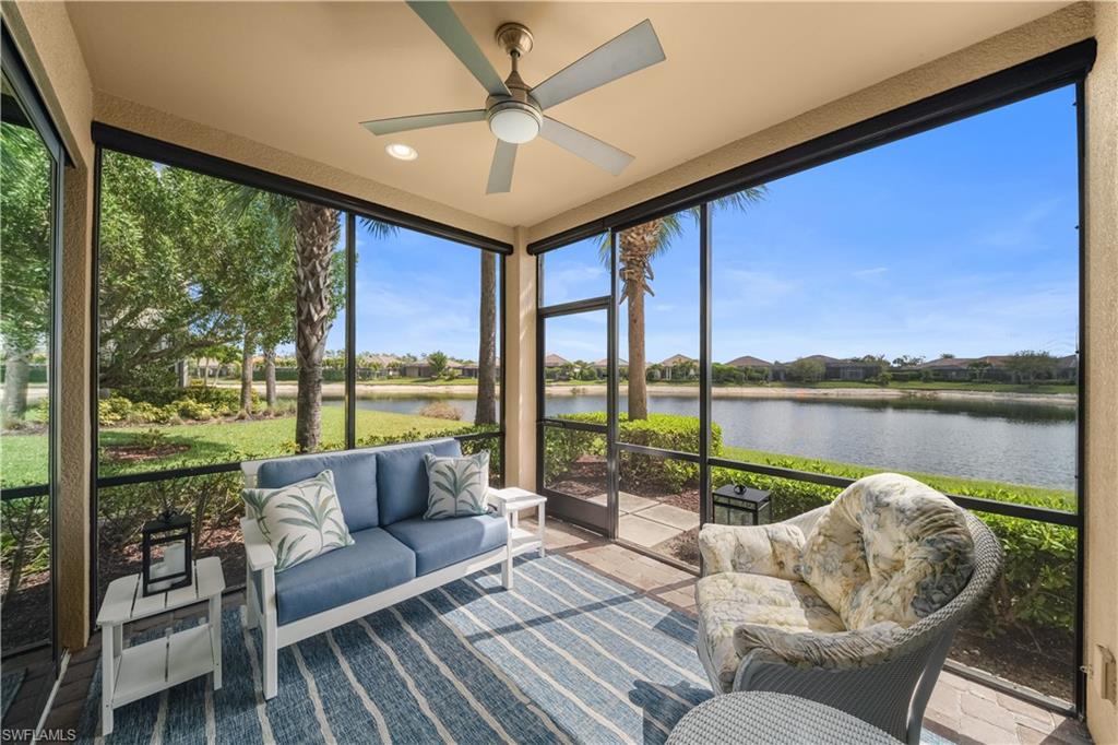 9685 Montelanico Loop, Unit 101 Naples, FL 34119 - Photo 13 of 49 a living room with furniture and a floor to ceiling window