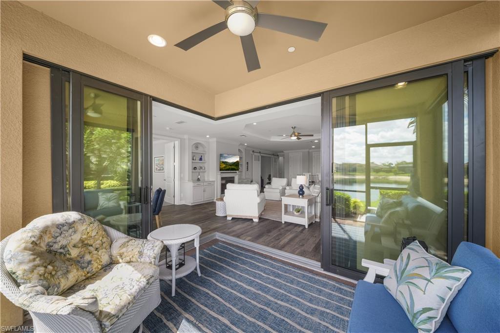 9685 Montelanico Loop, Unit 101 Naples, FL 34119 - Photo 15 of 49 a living room with furniture and a large window