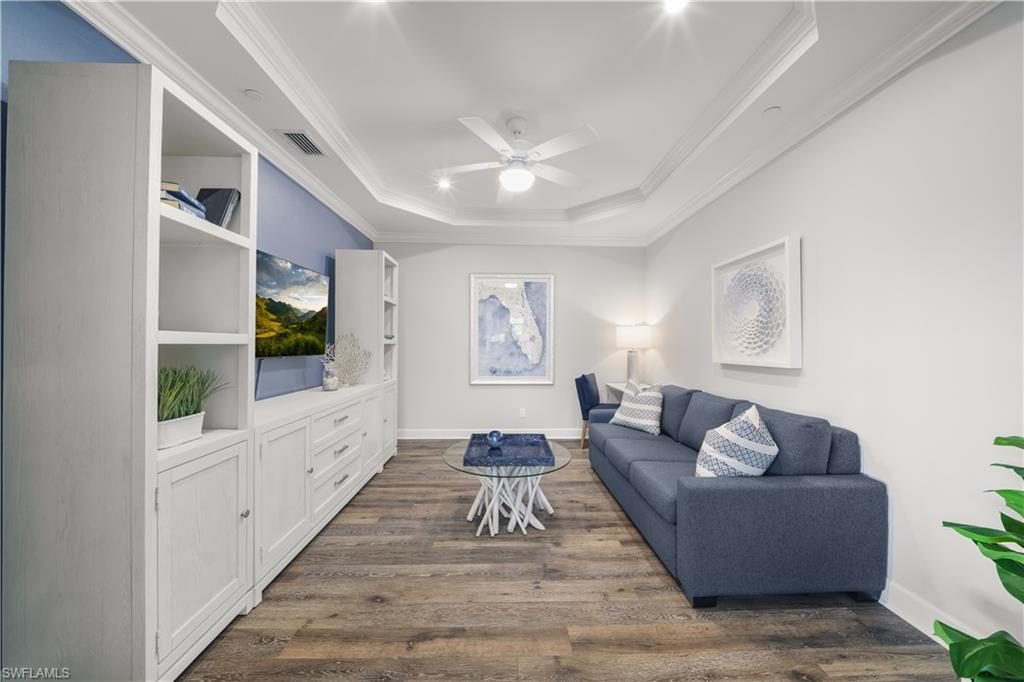 9685 Montelanico Loop, Unit 101 Naples, FL 34119 - Photo 17 of 49 a living room with furniture and a large window