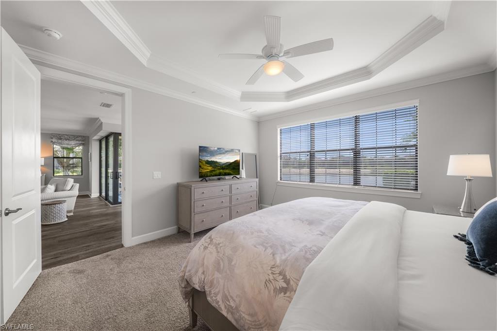 9685 Montelanico Loop, Unit 101 Naples, FL 34119 - Photo 19 of 49 a spacious bedroom with a large bed and a window