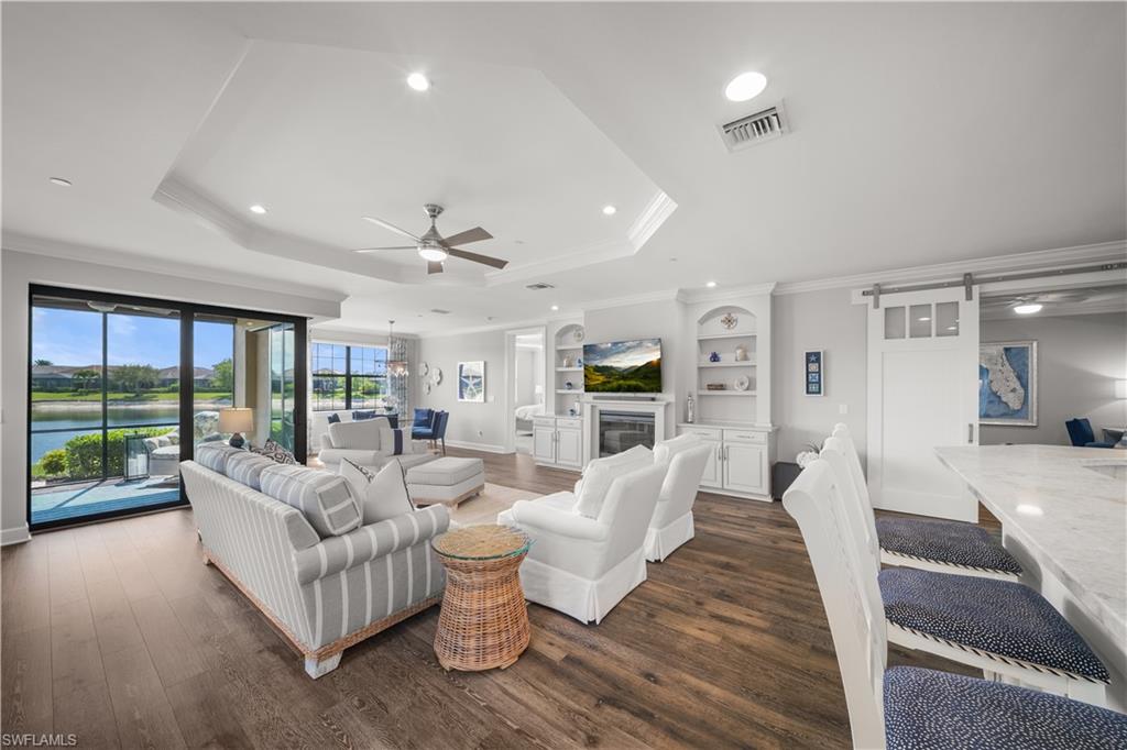 9685 Montelanico Loop, Unit 101 Naples, FL 34119 - Photo 2 of 49 a living room with furniture and a large window