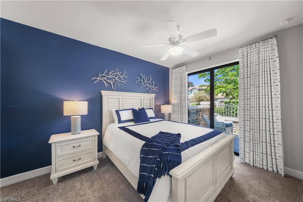 9685 Montelanico Loop, Unit 101 Naples, FL 34119 - Photo 23 of 49 a large bed sitting in a bedroom next to a window