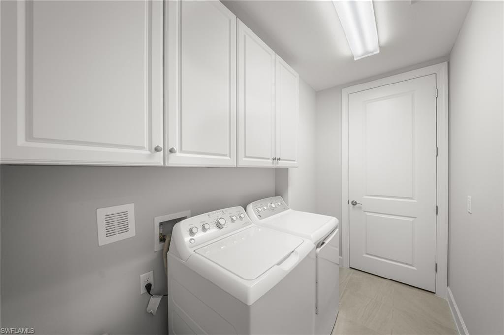 9685 Montelanico Loop, Unit 101 Naples, FL 34119 - Photo 25 of 49 a utility room with dryer and washer