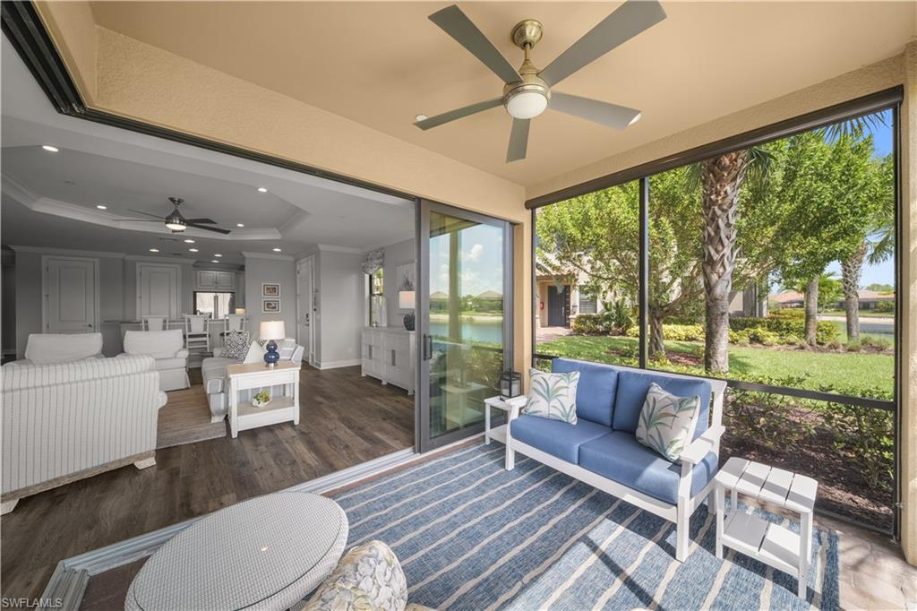 9685 Montelanico Loop, Unit 101 Naples, FL 34119 - Photo 27 of 49 a living room with furniture and a large window