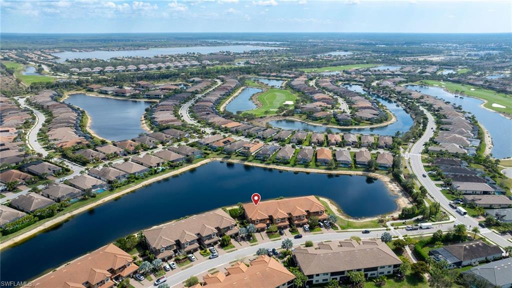 9685 Montelanico Loop, Unit 101 Naples, FL 34119 - Photo 30 of 49 an aerial view of a house with a lake view